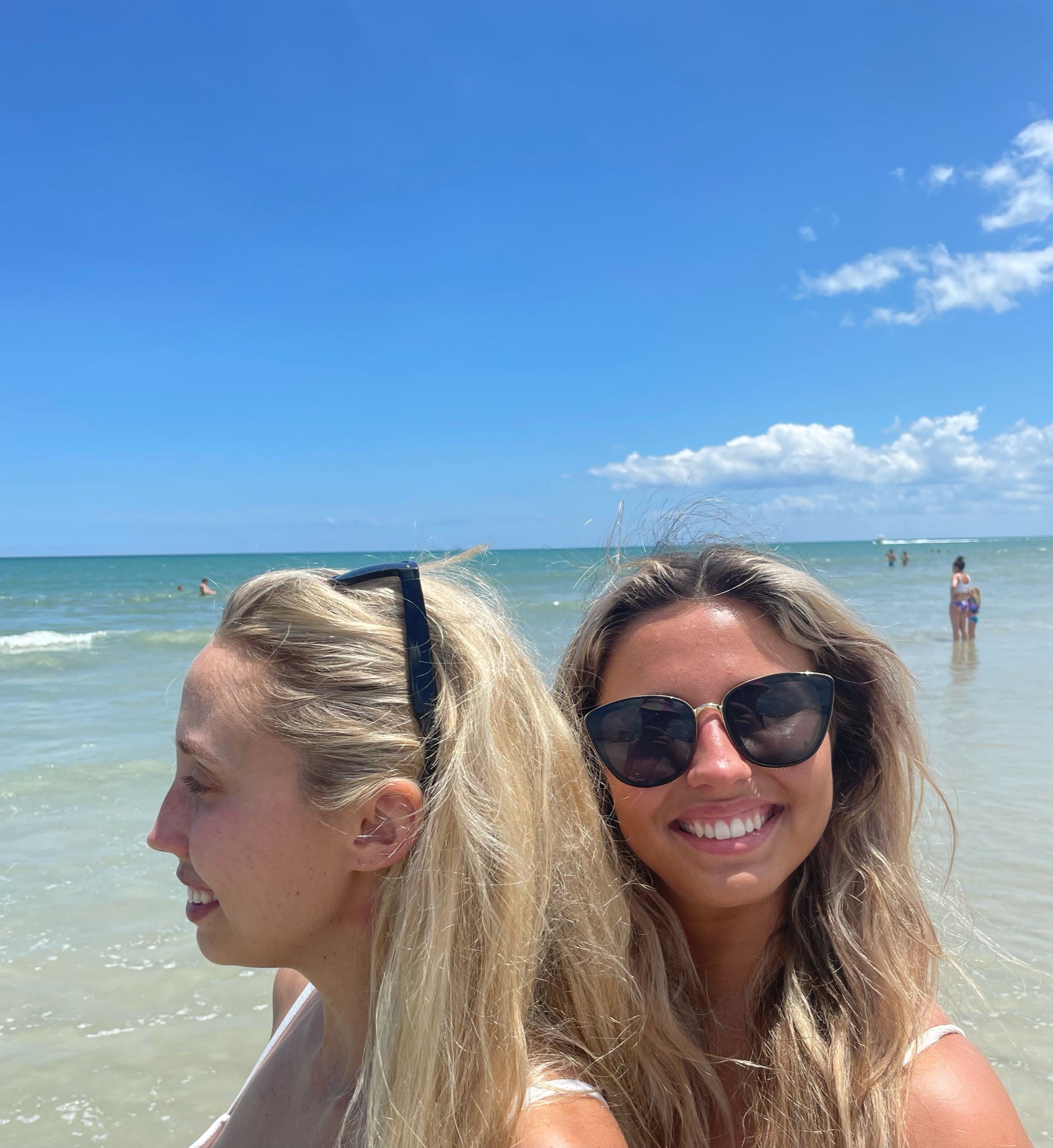 Two girls at the beach wearing StaysOn Eyewear
