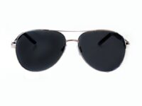 A pair of sunglasses with black lenses on top of a white background.