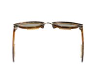 A pair of glasses with brown frames and black rivets.