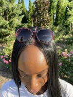 A woman with long hair wearing sunglasses.